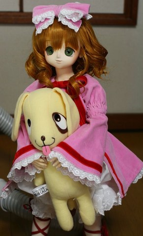 1girl blonde_hair bloomers blurry bow brown_hair depth_of_field doll dress frills green_eyes hair_bow hina_ichigo hinaichigo long_sleeves looking_at_viewer photo pink_bow pink_dress solo standing stuffed_animal underwear