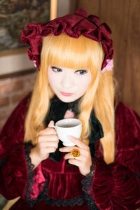 Rating: Safe Score: 0 Tags: 1girl bangs blonde_hair blue_eyes blurry blurry_background cup depth_of_field flower frills holding holding_cup lips lolita_fashion long_hair long_sleeves looking_at_viewer red_dress shinku sitting smile solo teacup User: admin