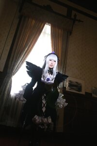 Rating: Safe Score: 0 Tags: 1girl black_dress black_wings closed_eyes dress frills gothic_lolita indoors long_hair long_sleeves silver_hair solo standing suigintou window wings User: admin