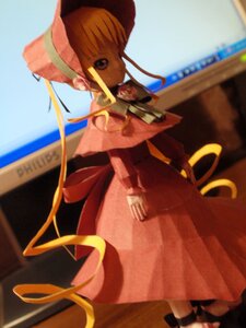 Rating: Safe Score: 0 Tags: 1girl blurry blurry_background brown_hair capelet depth_of_field doll dress full_body hat long_sleeves looking_at_viewer photo pink_headwear red_dress ribbon shinku solo standing User: admin