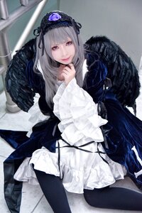 Rating: Safe Score: 0 Tags: 1girl black_wings dress feathers frills gothic_lolita hairband lolita_fashion long_hair long_sleeves looking_at_viewer silver_hair sitting smile solo suigintou wings User: admin