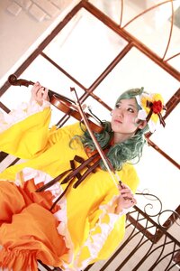 Rating: Safe Score: 0 Tags: 1girl bow_(instrument) flower green_hair hair_flower hair_ornament indoors instrument kanaria long_hair long_sleeves music playing_instrument solo violin window yellow_dress User: admin