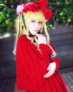 Rating: Safe Score: 0 Tags: 1girl bangs blonde_hair blue_eyes blurry blurry_background bonnet flower lips long_hair long_sleeves looking_at_viewer red_capelet red_dress shinku solo User: admin