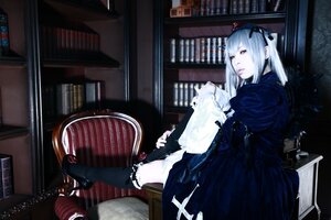 Rating: Safe Score: 0 Tags: 1girl book book_stack bookshelf dress gothic_lolita indoors library lolita_fashion ribbon sitting solo suigintou twintails User: admin