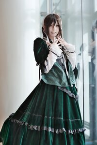 Rating: Safe Score: 0 Tags: 1girl blurry blurry_background brown_hair depth_of_field dress frills green_dress long_hair long_sleeves looking_at_viewer smile solo standing suiseiseki User: admin