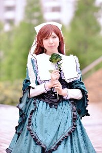 Rating: Safe Score: 0 Tags: 1girl apron blue_dress blurry blurry_background brown_hair depth_of_field dress flower frills head_scarf long_hair long_sleeves looking_at_viewer outdoors photo smile solo standing suiseiseki User: admin