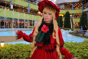 Rating: Safe Score: 0 Tags: 1girl blonde_hair blurry blurry_background bonnet building city depth_of_field dress flower lips long_hair long_sleeves looking_at_viewer outdoors photo_background red_dress rose shinku solo User: admin