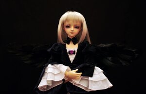 Rating: Safe Score: 0 Tags: 1girl bangs black_background blonde_hair blunt_bangs bow doll dress frills lips long_hair long_sleeves realistic solo suigintou wings User: admin