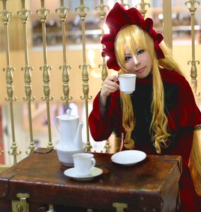 Rating: Safe Score: 0 Tags: 1girl blonde_hair blue_eyes blurry bonnet cup depth_of_field indoors long_hair looking_at_viewer saucer shinku sitting smile solo table teacup User: admin
