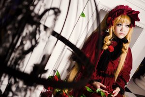 Rating: Safe Score: 0 Tags: 1girl bangs blonde_hair blue_eyes blurry blurry_foreground bonnet depth_of_field dress flower long_hair long_sleeves looking_at_viewer red_dress rose shinku sitting solo User: admin