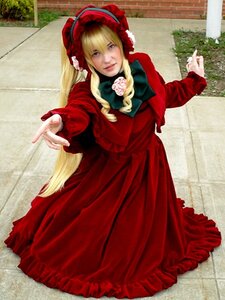 Rating: Safe Score: 0 Tags: 1girl blonde_hair blue_eyes bonnet bow dress fence flower long_hair long_sleeves looking_at_viewer red_dress rose shinku solo User: admin