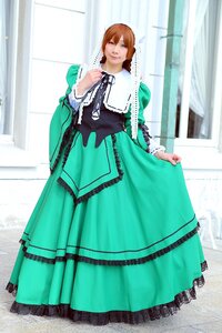 Rating: Safe Score: 0 Tags: 1girl brown_hair dress green_dress green_eyes long_sleeves looking_at_viewer skirt_hold smile solo standing suiseiseki window User: admin
