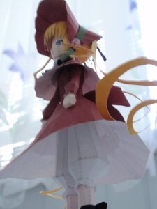 Rating: Safe Score: 0 Tags: 1girl blonde_hair blue_eyes blurry blurry_background blurry_foreground bonnet depth_of_field doll dress hat long_hair long_sleeves looking_at_viewer looking_back outdoors shinku solo standing User: admin