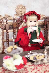 Rating: Safe Score: 0 Tags: 1girl blonde_hair blurry blurry_background blurry_foreground bonnet closed_eyes cup depth_of_field dress flower food frills hairband holding_cup long_hair long_sleeves photo red_dress saucer shinku sitting solo table teacup User: admin