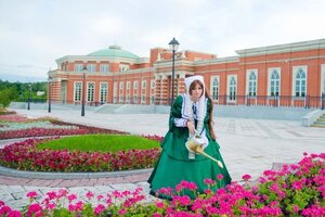 Rating: Safe Score: 0 Tags: 1girl brown_hair building city day dress flower garden green_dress hood outdoors scenery sky solo standing suiseiseki User: admin
