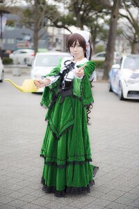 Rating: Safe Score: 0 Tags: 1girl blurry blurry_background blurry_foreground brown_hair depth_of_field dress green_dress green_skirt long_sleeves outdoors solo standing suiseiseki User: admin