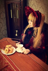 Rating: Safe Score: 0 Tags: 1girl blonde_hair blue_eyes bonnet dress flower food long_hair rose shinku sitting solo table teacup User: admin