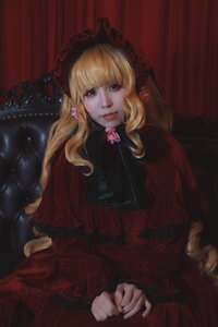 Rating: Safe Score: 0 Tags: 1girl blonde_hair blue_eyes capelet curtains dress flower lips long_hair long_sleeves looking_at_viewer red_dress shinku sitting smile solo User: admin