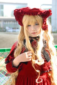 Rating: Safe Score: 0 Tags: 1girl bangs blonde_hair blue_eyes blurry blurry_background bonnet depth_of_field dress flower lips long_hair long_sleeves looking_at_viewer red_dress rose shinku smile solo User: admin