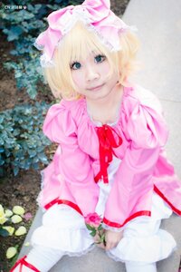 Rating: Safe Score: 0 Tags: 1girl blonde_hair blue_eyes blurry blurry_background bow depth_of_field dress flower frills hinaichigo lips long_sleeves looking_at_viewer outdoors photo pink_dress realistic ribbon short_hair sitting smile solo User: admin