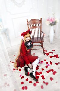 Rating: Safe Score: 0 Tags: 1girl blonde_hair blue_eyes blurry boots bow dress flower long_hair petals red_dress shinku sitting solo User: admin