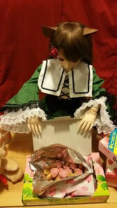 Rating: Safe Score: 0 Tags: 1girl animal_ears apron brown_hair doll dress food green_dress long_sleeves red_background solo suiseiseki User: admin