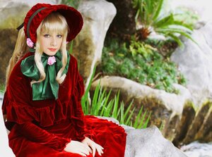 Rating: Safe Score: 0 Tags: 1girl bangs blonde_hair blue_eyes blurry blurry_background bonnet depth_of_field dress flower long_hair long_sleeves looking_at_viewer photo red_capelet red_dress shinku sitting solo User: admin