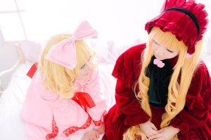 Rating: Safe Score: 0 Tags: 2girls bangs blonde_hair blue_eyes blurry bonnet bow closed_eyes depth_of_field dress hair_bow long_hair long_sleeves multiple_cosplay multiple_girls pink_bow red_dress shinku sitting striped tagme User: admin