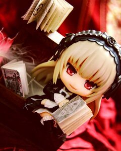 Rating: Safe Score: 0 Tags: 1girl blonde_hair book doll dress frills hairband long_hair long_sleeves looking_at_viewer open_book red_eyes sitting solo suigintou User: admin