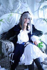 Rating: Safe Score: 0 Tags: 1girl blurry blurry_background blurry_foreground depth_of_field dress feathers flower hairband long_hair long_sleeves silver_hair sitting solo suigintou very_long_hair wings User: admin