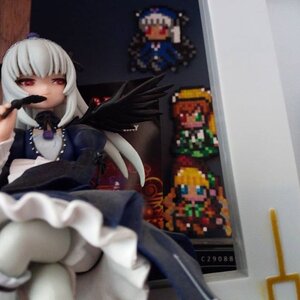 Rating: Safe Score: 0 Tags: 1girl black_wings blurry blurry_foreground depth_of_field doll dress frills long_hair photo red_eyes solo suigintou white_hair wings User: admin