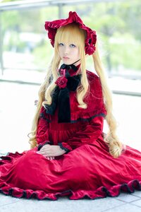 Rating: Safe Score: 0 Tags: 1girl bangs blonde_hair blue_eyes blurry blurry_background bonnet bow depth_of_field dress flower frills lips long_hair long_sleeves pink_rose red_dress red_flower red_rose rose shinku sitting solo User: admin