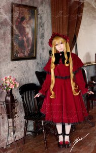 Rating: Safe Score: 0 Tags: 1girl blonde_hair blue_eyes bonnet capelet dress flower long_hair looking_at_viewer red_capelet red_dress shinku shoes sitting solo User: admin