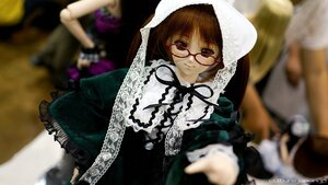 Rating: Safe Score: 0 Tags: blurry blurry_background blurry_foreground brown_eyes brown_hair depth_of_field doll dress frills glasses hood looking_at_viewer multiple_girls photo pov red-framed_eyewear smile solo solo_focus suiseiseki User: admin