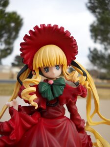 Rating: Safe Score: 0 Tags: 1girl bangs blonde_hair blue_eyes blurry blurry_background blurry_foreground bonnet bow bowtie capelet depth_of_field doll dress drill_hair flower frills green_bow long_hair long_sleeves looking_at_viewer outdoors photo red_dress shinku sidelocks solo standing twin_drills twintails User: admin