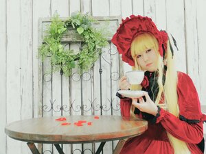 Rating: Safe Score: 0 Tags: 1girl bangs blonde_hair blue_eyes bonnet cup dress flower holding_cup long_hair plant red_dress saucer shinku sitting solo teacup User: admin