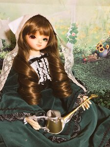 Rating: Safe Score: 0 Tags: 1girl brown_hair doll dress flower frills green_eyes heterochromia lolita_fashion long_hair long_sleeves sitting smile solo suiseiseki User: admin