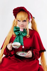 Rating: Safe Score: 0 Tags: 1girl blonde_hair blue_eyes bonnet bow bowtie capelet cup dress flower green_bow green_neckwear holding_cup long_hair looking_at_viewer red_capelet red_dress saucer shinku sitting solo tea teacup very_long_hair User: admin