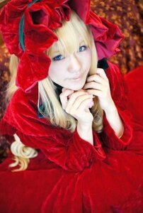 Rating: Safe Score: 0 Tags: 1girl blonde_hair blue_eyes blurry bonnet bow depth_of_field dress flower long_hair long_sleeves looking_at_viewer red_dress rose shinku smile solo User: admin