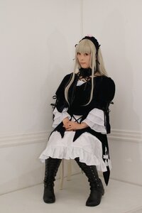 Rating: Safe Score: 0 Tags: 1girl black_footwear blonde_hair boots closed_mouth cross-laced_footwear dress frills full_body long_hair long_sleeves sitting solo suigintou User: admin