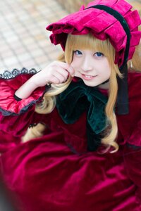 Rating: Safe Score: 0 Tags: 1girl bangs blonde_hair blue_eyes blurry blurry_background bonnet depth_of_field dress lolita_fashion long_hair long_sleeves looking_at_viewer red_dress shinku smile solo User: admin