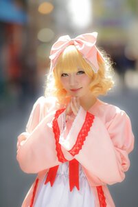 Rating: Safe Score: 0 Tags: 1girl bangs blonde_hair blue_eyes blurry blurry_background bow curly_hair depth_of_field dress frills hair_bow hinaichigo lips looking_at_viewer pink_bow realistic short_hair smile solo upper_body User: admin
