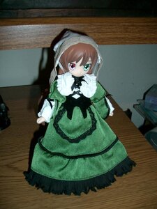 Rating: Safe Score: 0 Tags: 1girl brown_hair doll dress green_dress heterochromia long_hair long_sleeves looking_at_viewer red_eyes sitting solo suiseiseki User: admin