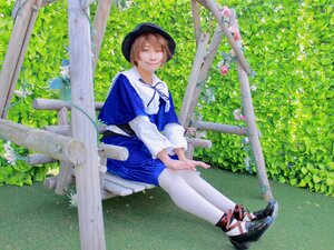 Rating: Safe Score: 0 Tags: 1girl blonde_hair blue_dress day dress flower hat looking_at_viewer outdoors pantyhose plant shoes short_hair sitting smile solo tree white_legwear User: admin