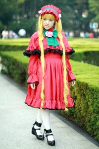 Rating: Safe Score: 0 Tags: 1girl black_footwear blonde_hair blurry blurry_background bonnet bow capelet depth_of_field dress full_body long_hair long_sleeves outdoors pantyhose photo pink_dress shinku shoes solo standing twintails white_legwear User: admin