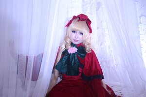 Rating: Safe Score: 0 Tags: 1girl bangs blonde_hair blue_eyes bow capelet curtains dress flower lips long_hair long_sleeves looking_at_viewer red_dress rose shinku sitting solo User: admin