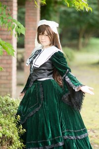 Rating: Safe Score: 0 Tags: 1girl blurry blurry_background brown_hair day depth_of_field dress frills green_dress green_eyes long_hair long_sleeves looking_at_viewer outdoors plant solo standing suiseiseki User: admin