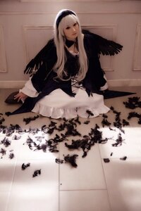 Rating: Safe Score: 0 Tags: 1girl bangs black_dress black_wings blonde_hair closed_mouth dress feathers frills hairband indoors long_hair long_sleeves looking_at_viewer sitting solo suigintou User: admin