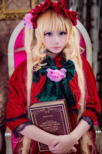 Rating: Safe Score: 0 Tags: 1girl bangs blonde_hair blue_eyes blurry blurry_background blurry_foreground book depth_of_field flower holding holding_book lips long_hair looking_at_viewer open_book red_dress rose shinku sitting solo User: admin