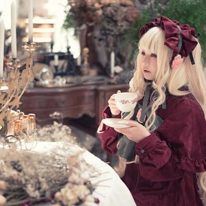 Rating: Safe Score: 0 Tags: 1girl blonde_hair blue_eyes blurry blurry_background bonnet bow cup depth_of_field holding holding_cup long_hair outdoors saucer shinku sitting solo tea teacup User: admin